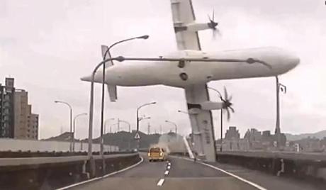 The plane clipped a highway bridge and then careened into the Keelung River.
