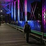 A pedestrian crosses the Old Northern Avenue Bridge one evening last May.