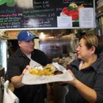 Taqueria Casa Real owner Ricky Reyes, with his mother, Elena, said it is hard to keep taco prices low.