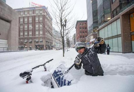 Ricardo Hernandez removed snow from the sidewalk along Boylston Street in Boston this past week. Another storm on tap could leave Mass. with up to two feet of snow by Tuesday.
