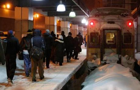 Commuters made their way to a train at South Station Monday before the MBTA halted service.
