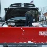 A plow operator worked on his vehicle in a Methuen parking lot on Monday. Some plow drivers last year waited well into spring for the state to pay for work done in the winter. 