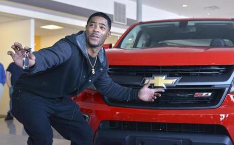 New England Patriots cornerback Malcolm Butler poses with a Chevrolet pickup truck he was presented Tuesday, Feb. 10, 2015, at a dealership in Norwood, Mass. The truck was intended to go to Patriots quarterback Tom Brady as Super Bowl Most Valuable Player. But Brady and the automaker determined that Butler should receive it in recognition for his game-saving interception that clinched the team's Super Bowl XLIX victory. (AP Photo/Josh Reynolds) 

