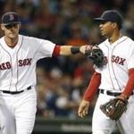 Boston Red Sox's Will Middlebrooks, left, taps teammate Xander Bogaerts after the two collided while fielding a pop out by Baltimore Orioles' Adam Jones during the fourth inning of a baseball game in Boston, Tuesday, Sept. 9, 2014. (AP Photo/Michael Dwyer)