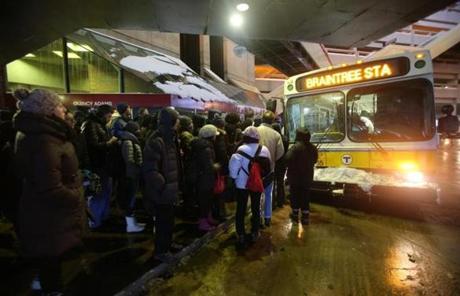 Riders waited for the bus at Quincy Adams station on the Red Line.
