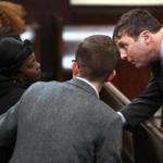 Carine Lamour, the mother of shooting victim Kenneth Lamour, spoke with assistant district attorney Ian Polumbaum in court on Thursday. Josiah Zachery, 18, pleaded not guilty tomurder and weapons charges.