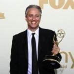 Television host Jon Stewart holds the Emmy award for the 