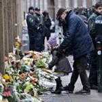 A memorial began to form hours after a guard was shot to death outside a synagogue in Copenhagen on Sunday.