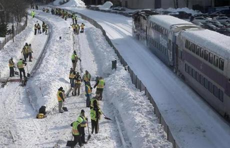 Crews shoveled snow from MBTA Red Line tracks on Tuesday.
