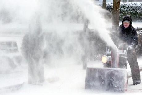 Steve Ricketts used a snow blower to clear a city sidewalk in Winchester, Va., on Tuesday.
