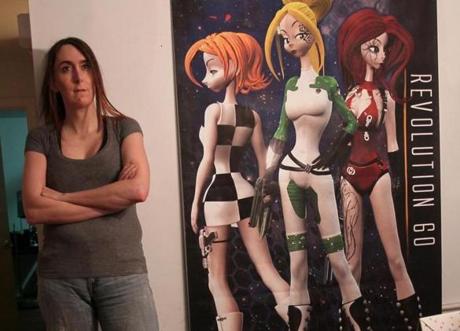Brianna Wu, head of development at Giant Spacekat, stood next to a poster of her video game characters.
