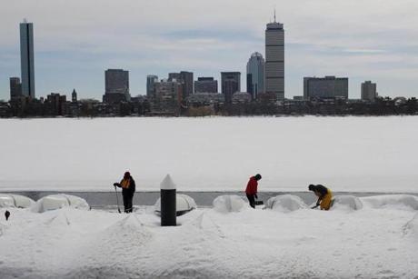 Left to right, Anthony Lawrence, Andre Gagne, and Wesley Reid  worked in the bitter cold t to shovel out the docks at the MIT Sailing Pavilion on Tuesday.
