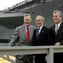 President George W. Bush, center, with his father former President George H.W. Bush, left, and his brother Jeb Bush, thengovernor of Florida, are seen in a photo from Oct. 7, 2006, following a christening ceremony the aircraft carrier George H.W. Bush.