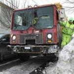 Capital Waste Services driver Angelo Santostefano tried to clear part of a snowbank on Bakersfield Street.