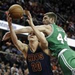 Boston Celtics' Tyler Zeller (44) fouls Cleveland Cavaliers' Timofey Mozgov (20), from Russia, in the first quarter of an NBA basketball game Tuesday, March 3, 2015, in Cleveland. (AP Photo/Mark Duncan)