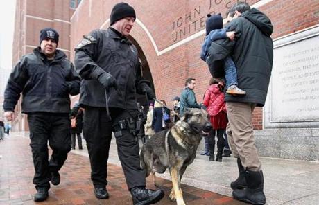 A K-9 officer and his dog patrolled outside the court Wednesday.
