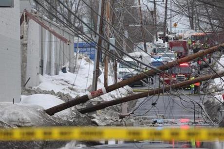 A roof collapse caused utility poles to be knocked down across Sprague Street.
