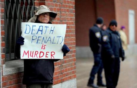 A demonstrator held a sign outside the trial in Boston.
