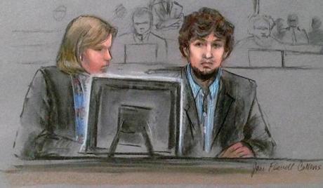 In this courtroom sketch, Dzhokhar Tsarnaev, right, and defense attorney Judy Clarke are depicted watching evidence displayed on a monitor during his federal death penalty trial. 
