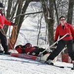 Ski patrol members Claude Jean-Calixte, Luke Conley (in the sled), and Mary Thomas go through training at the Blue Hills Ski Area.