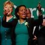 Governor Charlie Baker and Mayor Marty Walsh joined state Senator Linda Dorcena Forry (center) during a song at the St. Patrick?s Day breakfast Sunday in South Boston.