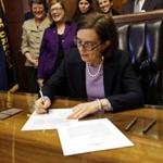 Oregon Governor Kate Brown signed an automatic voter registration bill Monday. 
