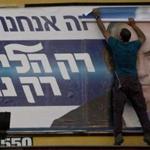 Workers removed a campaign billboard showing Prime Minister Benjamin Netanyahu.