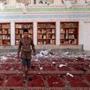 A Yemeni man inspected the damage following a bomb explosion at the Badr mosque in southern Sanaa. 