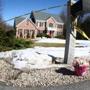 Flowers were placed by the mailbox in front of the home where three suspicious deaths took place in Bedford, N.H. 