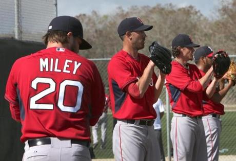 Fort Myers, FL - 02/23/15 - Boston Red Sox pitchers from l to r: Wade Miley, Rick Porcello, Clay Buchholz, and Eduardo Rodriguez, prepare to throw their scheduled bullpen sessions. Red Sox Spring Training. (Barry Chin/Globe Staff), Section: Sports, Reporter: Peter Abraham, Topic: 24Red Sox, LOID: 8.0.2717390732. 
