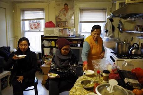 Activists Ruodi Duan, left, and Betty Fong work to protect tenants such a Pei Ying Yu, right, at 103 Hudson St.
