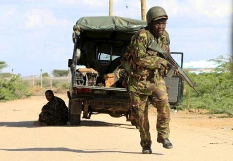 A Kenyan soldier ran for cover near the perimeter wall where attackers were holding up at the campus.
