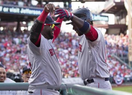 Shortstop Hanley Ramirez is congratulated by hitter David Ortiz after hitting a home run against the Philadelphia Phillies. 
