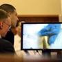 Aaron Hernandez (second from left) and attorney Charles Rankin viewed an image of bubble gum and a bullet shell during the trial Monday.