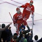 04/09/15: Boston, MA: BU's Jack Eichel (9) brings the fans oiut of their seats after he put a backhander from the slot by North Dakota goalie Zane McIntyre in the first period to put the Terriers ahead 1-0. Teammate Evan Rodrigues is at top. Boston University met North Dakato in the semi-finals of the NCAA Men's Ice Hockey 