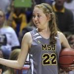 Mount St. Joseph's Lauren Hill gave a thumbs-up as she held the game ball during her first NCAA college basketball game against Hiram University.