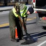 Scott Shea, a prolific paver in District 2, filled a pothole on Walk Hill Street in January.