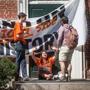 Tyler Van Valkenburg (left) and Maryssa Baron (center), members of Divest Harvard, spoke to a fellow student while blocking the entrance to an administration building. 