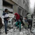 Syrian civilians ran through an Aleppo street Tuesday after a reported government airstrike.