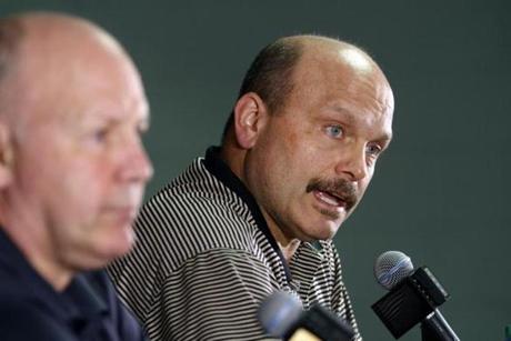 Peter Chiarelli (right) and coach Claude Julien held an end-of-season news conference on Monday.
