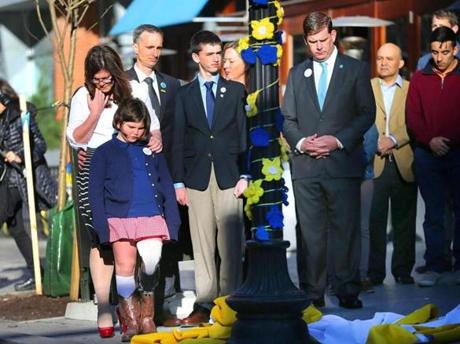 In front of the former Forum Restaurant, the Richard family helped unveil the Marathon banner Wednesday with Mayor Walsh.
