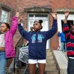 Destiny Tillman, 9, Imani Smith-Murphy, 8, and Alfredo Tillman, 9, displayed the ?hands up, don?t shoot? gesture in solidarity with protesters marching in Roxbury Saturday.