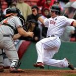 Red Sox catcher Ryan Hanigan slides home, evading the tag of Baltimore catcher Ryan Lavarnway for the sixth Red Sox run.