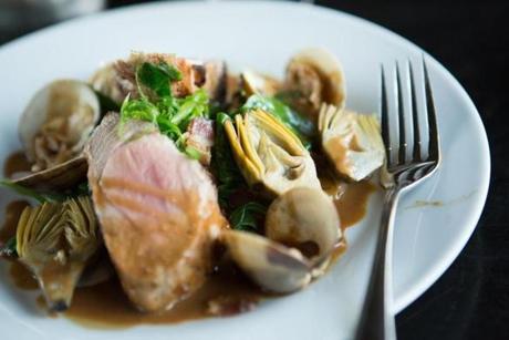 At Moonshine 152, from chef-owner Asia Mei, grilled pork tenderloin is served with clams, baby artichokes, leeks, and bacon-spiked greens in mushroom broth. 
