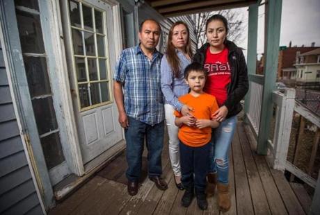 From left: Rene Bernal, Dora Sandoval, and Alexander and Dulce Bernal could face a rent increase for  their apartment in Roxbury.  
