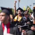 05/30/2014 BOSTON, MA Students stood up and cheered when asked who were the first of their families to go to college during the 2014 UMass Boston Commencement. (Aram Boghosian for The Boston Globe)