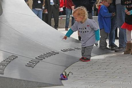 A young cousin of Sean Collier pointed to his memorial at MIT. 
