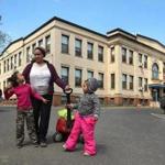 Temika Bennett and her three daughters outside a Holyoke preschool after the school day.