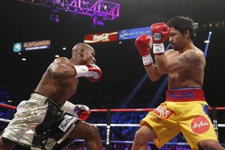 Floyd Mayweather Jr. (left) and Manny Pacquiao traded blows during Saturday?s welterweight unification bout.
