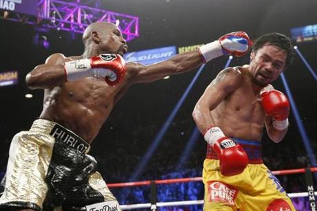 Floyd Mayweather Jr. hits Manny Pacquiao during their fight Saturday. Many pay-per-view customers experienced technical difficulties during the telecast.
